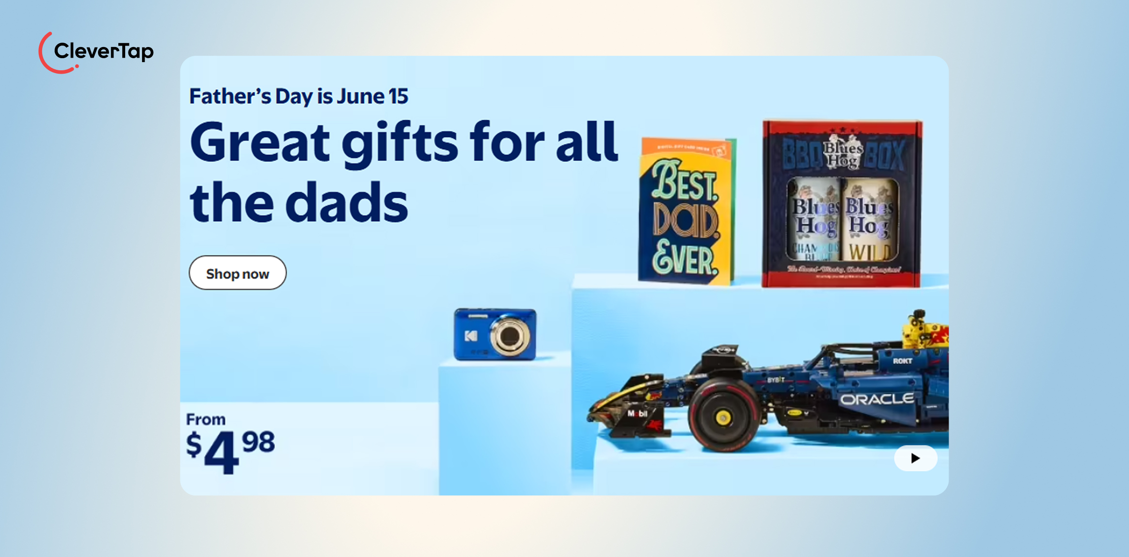 Walmart: Creating Urgency Around Holiday Shopping. Banner advertising Father's Day gifts; shows 'Best Dad Ever' book, Blues Hog BBQ set, a blue camera, and a race car on blue steps on a light blue gradient background.