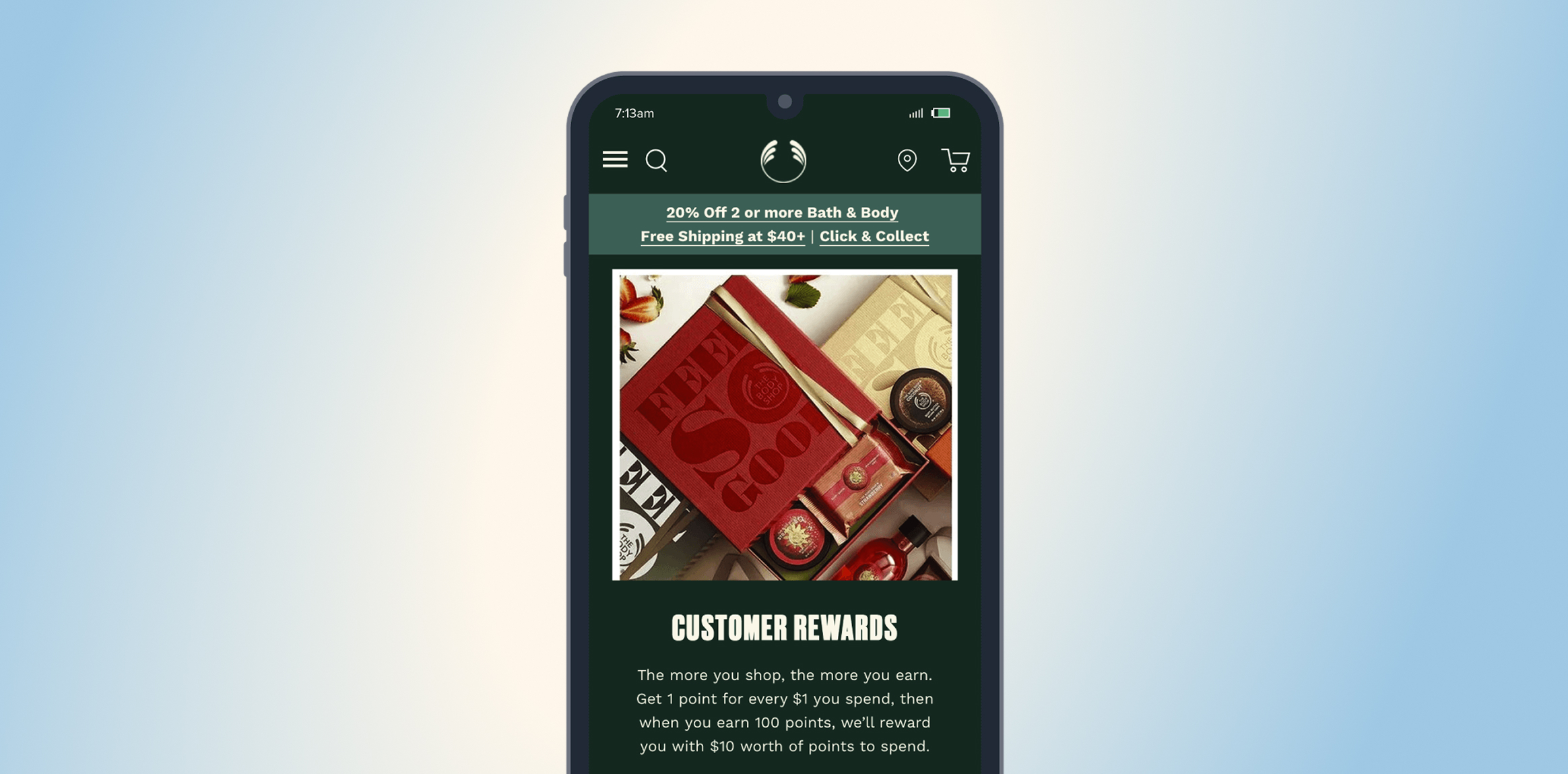 The Body Shop In Cosmetics:Retail. Smartphone screen showing a rewards app with a promo bar and a photo of gift boxes on a dark background.